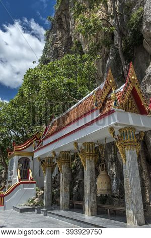 Thailand, Phetchaburi 19.07.2019 View Of Wat Tham Khao Yoi Cave, Buddhist Temple With Green Tree And