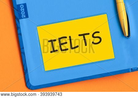 Ielts The Word Is Written In Black Letters On The Yellow Paper For Notes