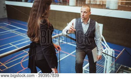 A Handsome Mature Man Entrepreneur With A Colsed Laptop In His Hand Is Having A Business Conversatio