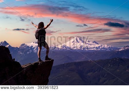 Adventurous Person Hiking In The Canadian Mountains. Colorful Sunrise Sky Art Render. Taken On The T