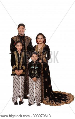 Portrait Of A Happy Family Wearing Traditional Javanese Clothes.