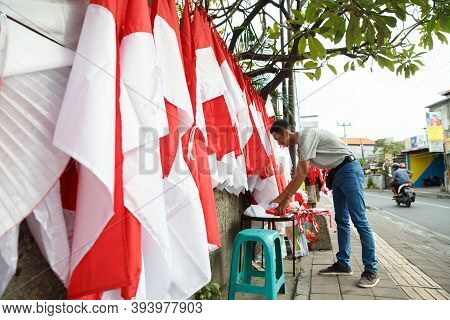 Portrait Of A Young Man Folding Flags