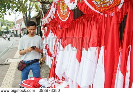 Portrait Of A Young Man Selling Flags