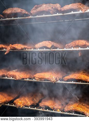 Smoke Rising Around A Slow Cooked Beef Brisket On A Smoker Barbecue Grilling Concept