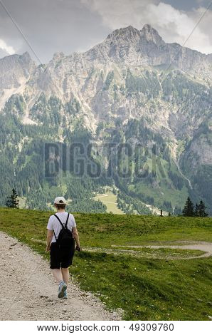 Woman Is Hiking In The Mountains