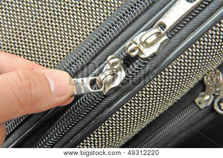 Detail zip with hand on a bag