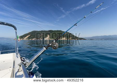 Fishing Rod On Boat With Island In Background