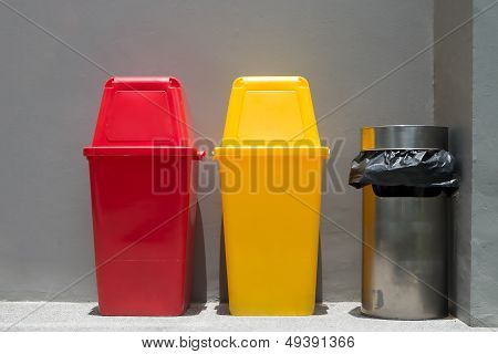 Colorful Bins And Smoke Bin Outside A Building