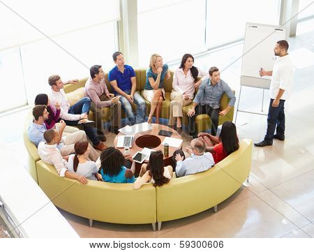 Businessman Making Presentation To Office Colleagues