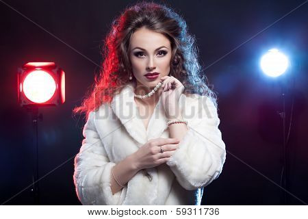Woman In Winter Fur With Jewellery And Two Lights Behind