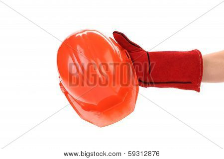 Hand in leather gloves holds hard hat.