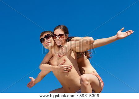 Portrait of a happy young couple enjoying at beach