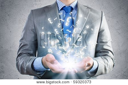 Close of businessman holding numerals in palms