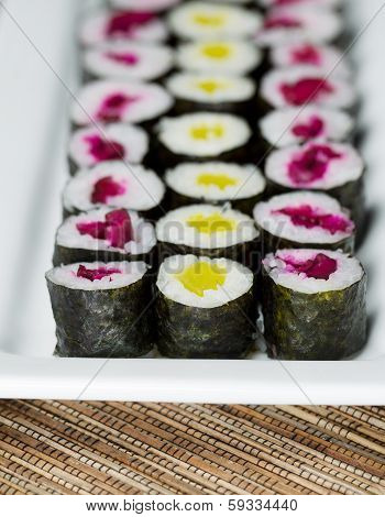Long Plate Filled With Pickled Hand Rolled Sushi
