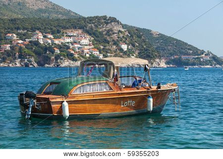 ZATON, CROATIA - AUG 18, 2012: Old boat in the sea in Zaton. Zaton is the favourite weekend resort of the inhabitants of Dubrovnik and their guests.