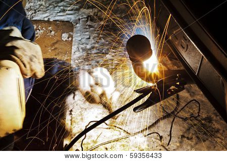 Welding Car Turnbuckle In Snow Field At Night