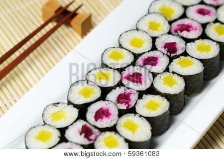 Fresh Hand Rolled Pickled Sushi In Large White Plate