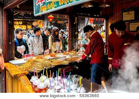 CHONGQING, CHINA - JAN 17: Unidentified merchants are selling traditional food on January  17, 2014 at Ciqikou Ancient Town, Chongqing, China.