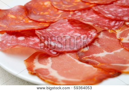 a tray with assorted embutidos, spanish cold cuts, such as chorizo, salchichon or lomo embuchado