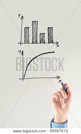 Businessman Drawing Chart And Other Infographics In Note Pad