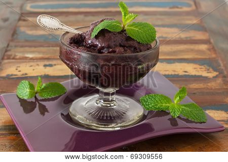 Acai Pulp In Glass With Fresh Mint On Purple Plate