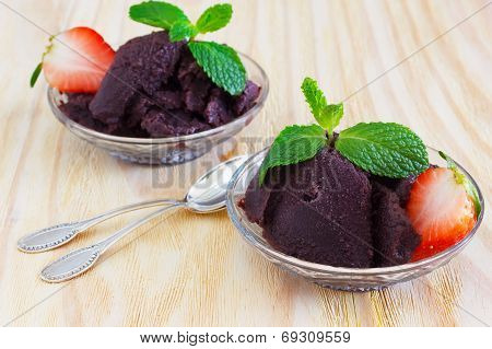 Acai Pulp In Glass With Strawberry And Fresh Mint With Two Spoons
