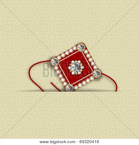 Beautiful maroon rakhi decorated with diamonds on brown background for Hindu community festival Raksha Bandhan celebrations.