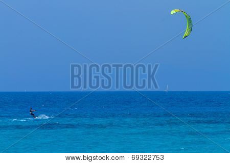 young kiter in the surrounding of turquoise sea kiting in Lefkas Greece