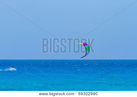 young kiter in the surrounding of turquoise sea kiting in Lefkas Greece