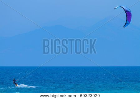 young kiter in the surrounding of turquoise sea kiting in Lefkas Greece