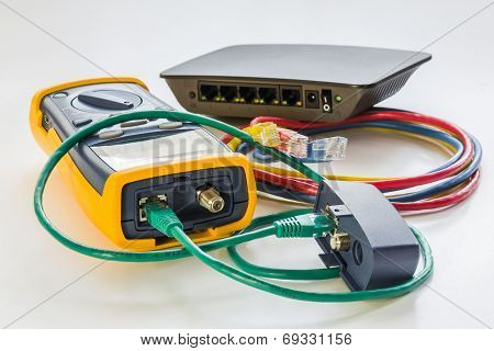 Network Tester And Small Switch With Various Color Rj45 Cables Connected For Testing
