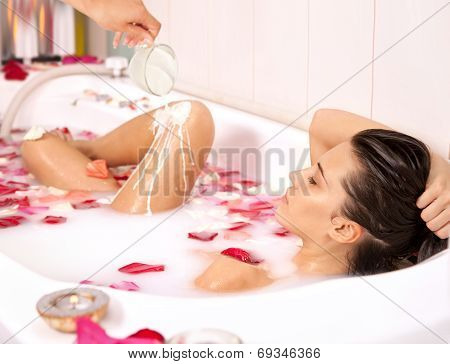 Attractive Naked Girl Enjoys A Bath With Milk And Rose Petals