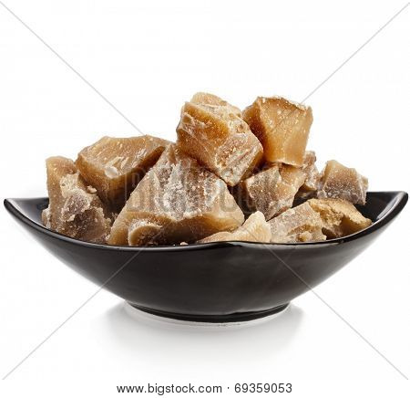 Beeswax sliced heap in black bowl isolated on a white background