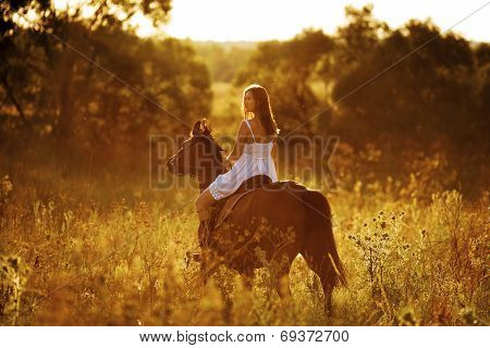 Young Woman Riding A Horse