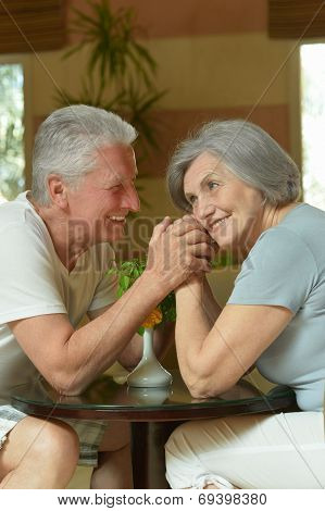 Old couple resting in hotel hall