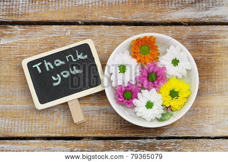 Thank you written with wooden letters and santini flowers