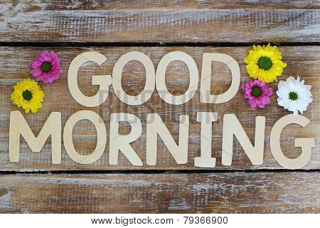 Good morning written with wooden letters and santini flowers