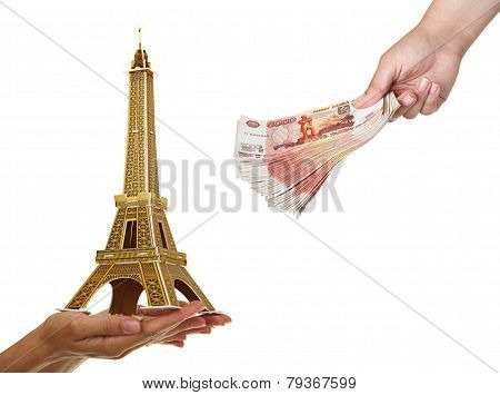 Model Eiffel Tower and a pack of five thousandth of notes in wom