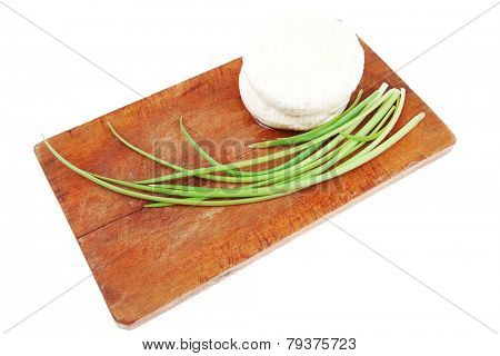dairy products : feta white cheese on cut board isolated over white background