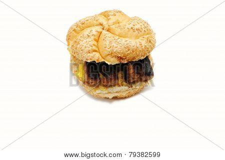 An Egg Sandwich Topped With Sausage
