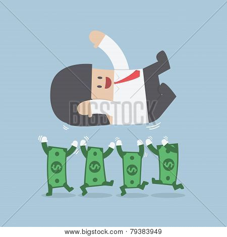Successful Businessman Being Throwing Up By Dollar Bill