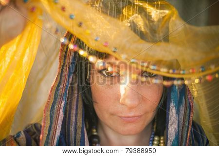 Young woman in a chador in the soft rays of the sun.