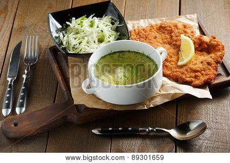 Chicken broth with egg, fried meat in batte