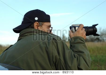 Muž s fotokamery