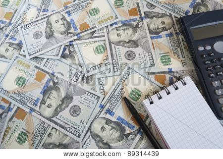 Calculator and dloknot against the background of US dollars