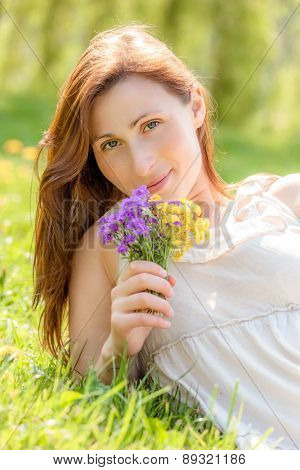 smiling bauty alone in green waiting for new love