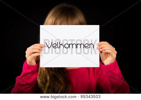 Child Holding Sign With Danish Word Velkommen - Welcome