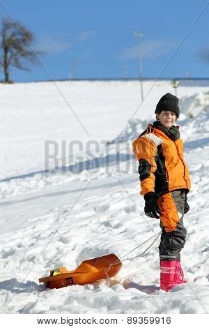 Cute Boy With Wool Cap In The Winter Plays With Bob