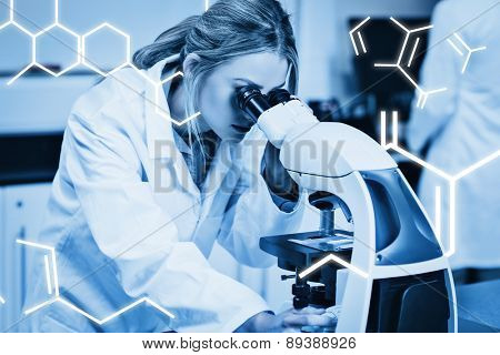 Science graphic against science student looking through microscope in the lab