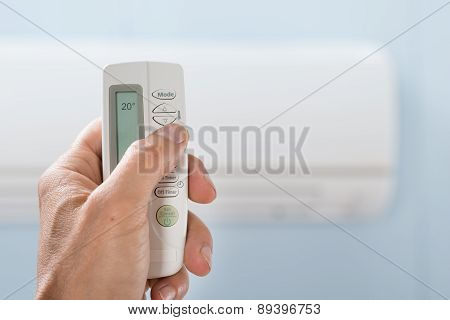 Person Hand Holding Air Conditioner Remote